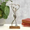 Transomnia Silver Metal Dancing Couple On Wooden Base Decoration 1 Transomnia Silver Metal Dancing Couple On Wooden Base Decoration -Campus Gifts Sales transomnia decc705 dancing couple with heart on wooden base lifestyle